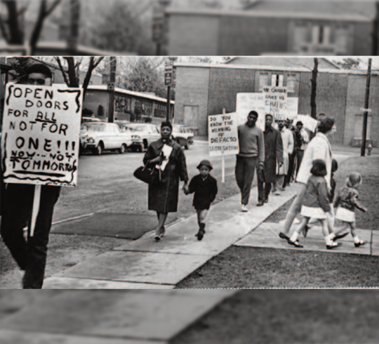 Outside Hartford's Noah Webster Elementary School, people protest against neighborhood school zones that created school segregation. 1964, uncredited, Hartford Public Library.