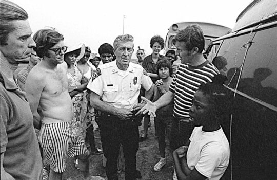 Ned Coll, right, confronted by a local police officer in Madison. 1971, Bob Adelman, Smithsonian Magazine.