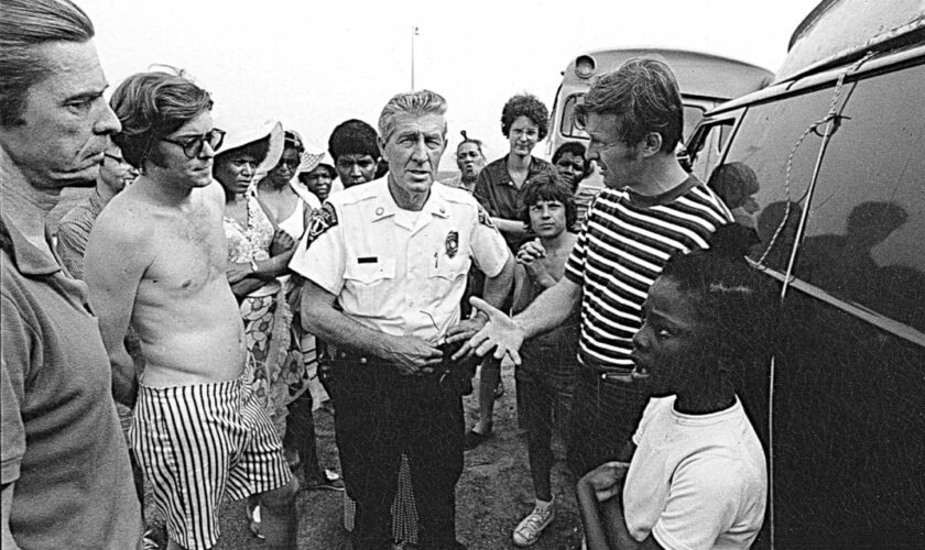 Ned Coll, right, confronted by a local police officer in Madison. 1971, Bob Adelman, Smithsonian Magazine.